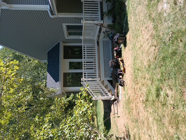 Finished Bedford deck rebuild and four-season porch addition with white PVC railings