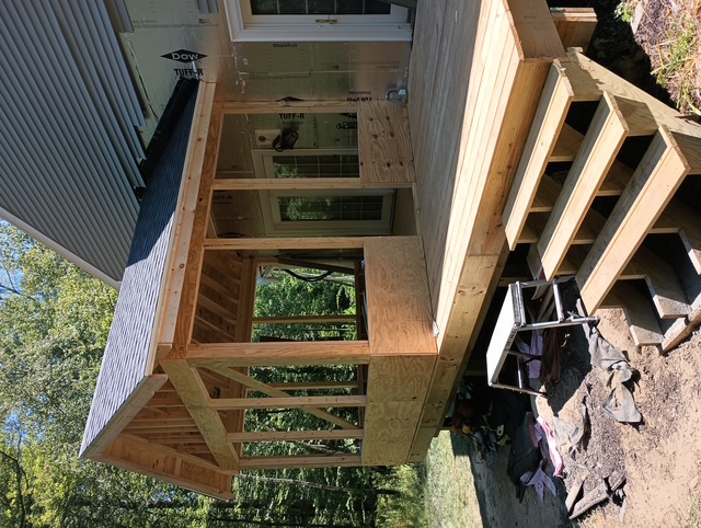 Front framing view of a four-season porch addition in Bedford