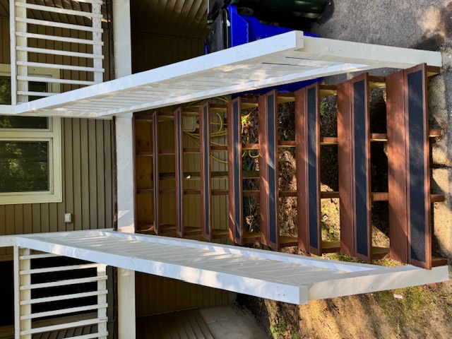 Close view of rebuilt exterior stairs with white railings in Goffstown