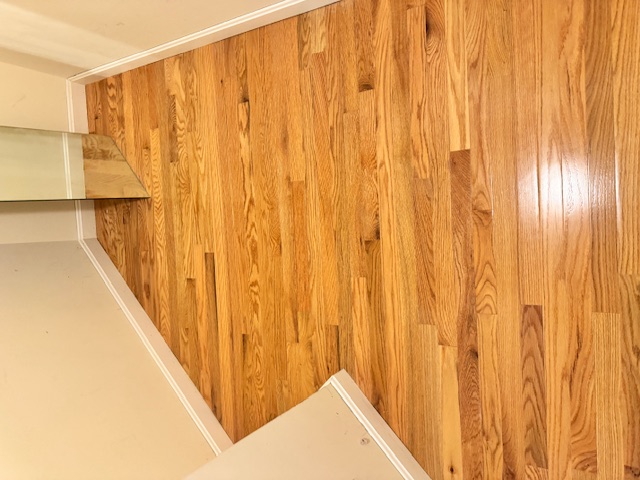 New hardwood flooring carried through a smaller Merrimack room