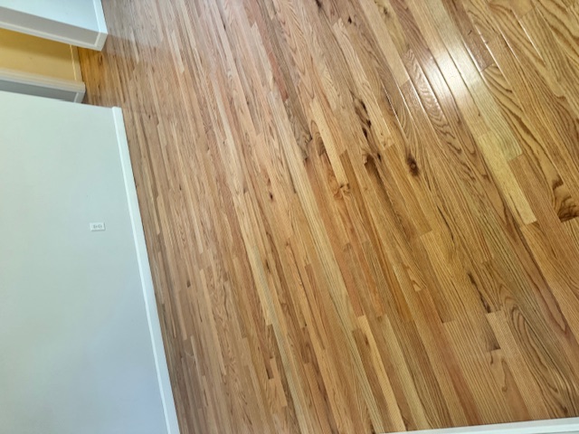 New hardwood flooring installed across a Merrimack living room